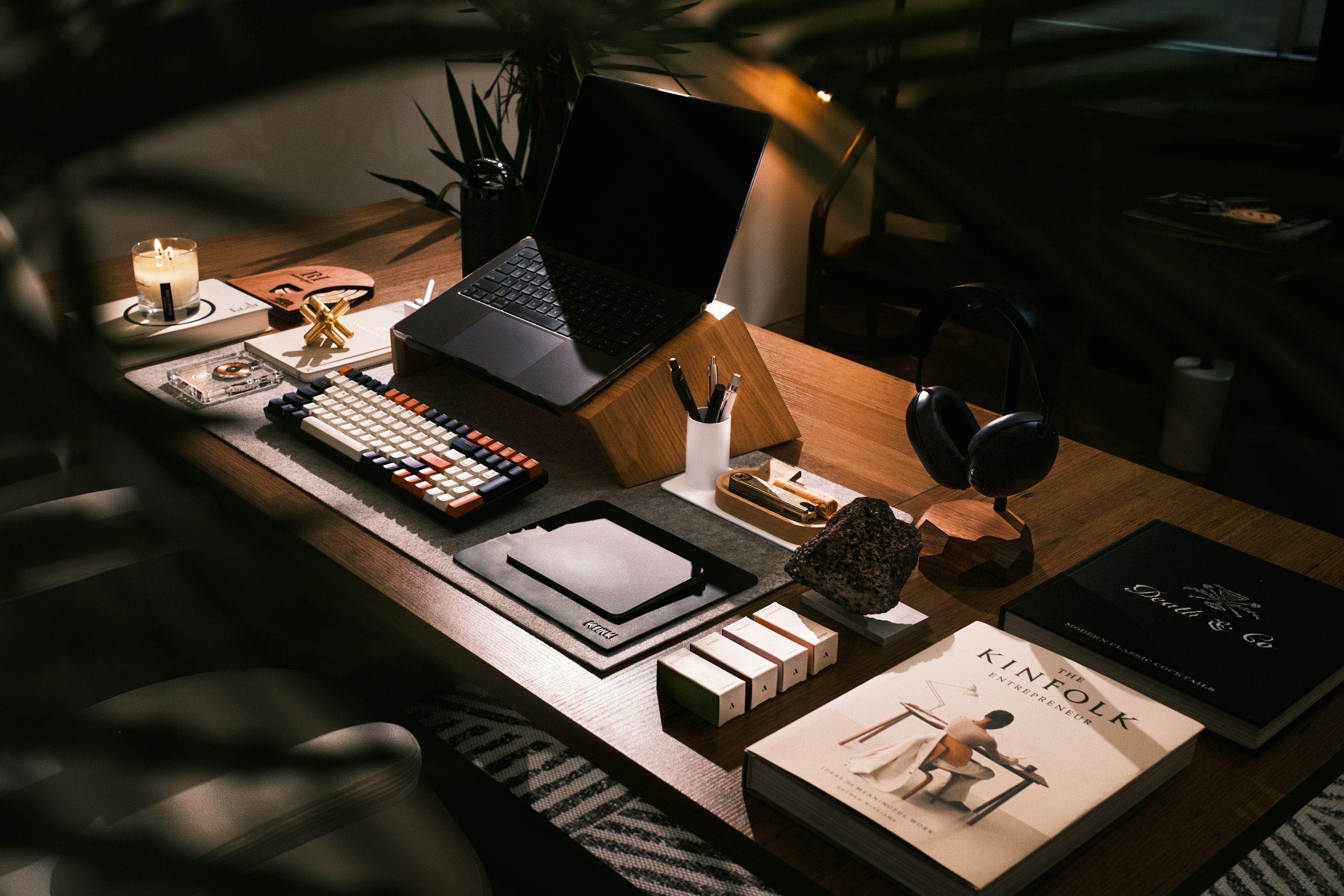 a modern desk setup with laptop and books in soft natural light