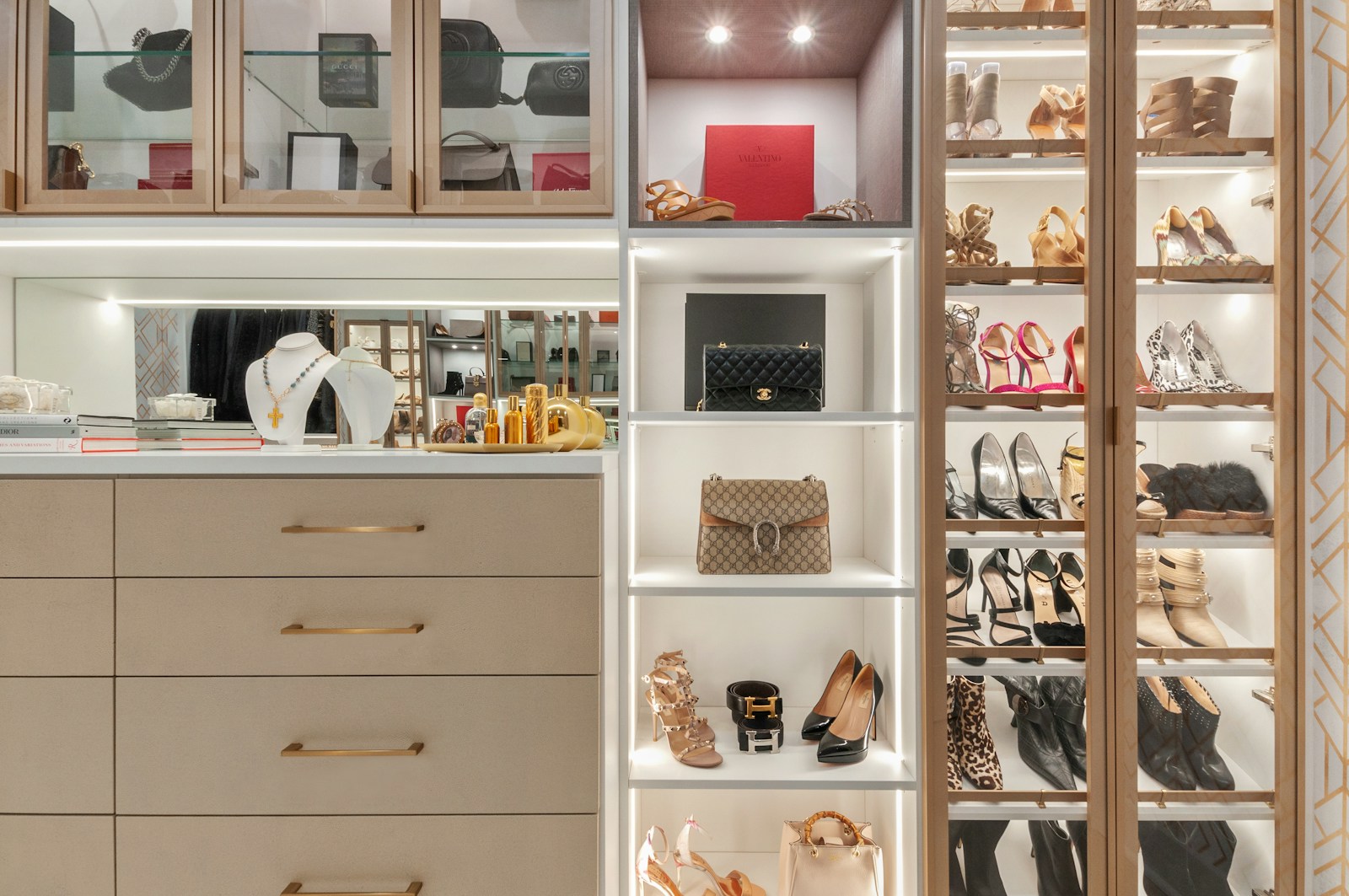 white wooden shelf unit with assorted neatly arranged items in a bright room